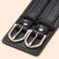 Load image into Gallery viewer, Close-up of the twin silver-tone buckles and stitched edge of the black cuff