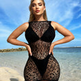 Load image into Gallery viewer, Black sheer floral-lace cover-up mini dress worn on the beach, front view