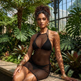 Cargar la imagen en la vista de la galería, Black open-net halter mini dress worn over black swimwear, front view