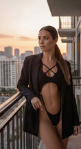 Load image into Gallery viewer, The bodysuit styled under an oversized blazer on a balcony at dusk