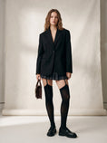 Cargar la imagen en la vista de la galería, Full length view of black garter stockings with a plaid pleated skirt, oversized blazer and loafers