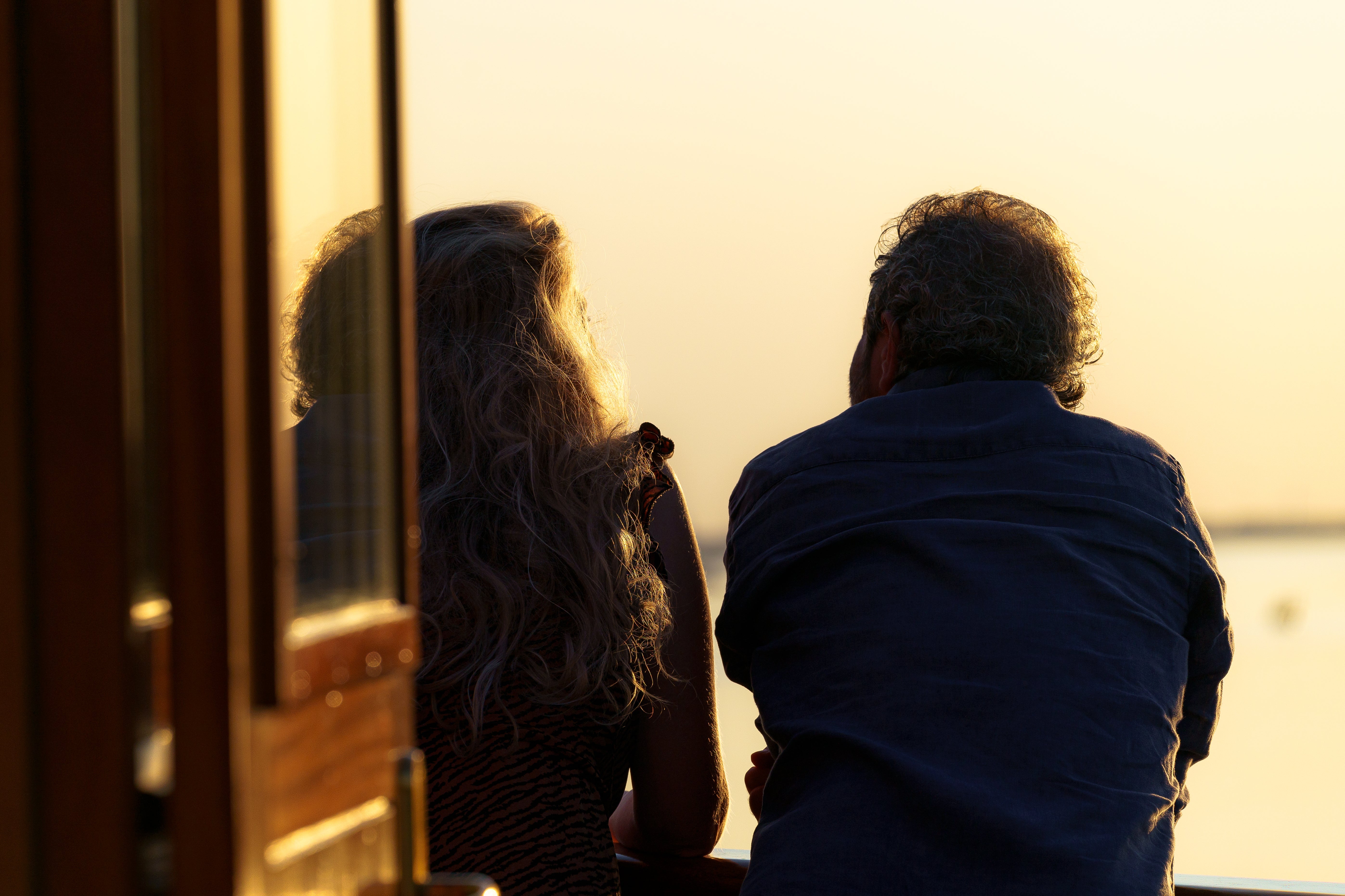 Couple on the deck of Icon of the Seas at sunset