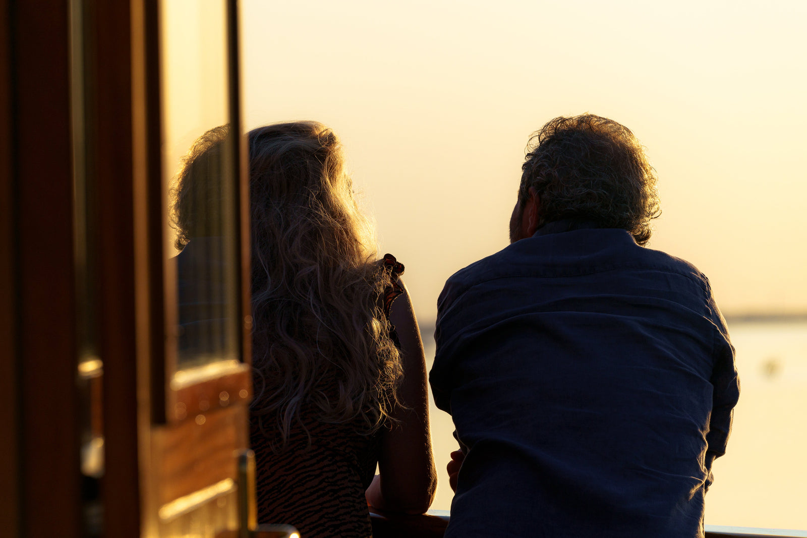 Couple on the deck of Icon of the Seas at sunset