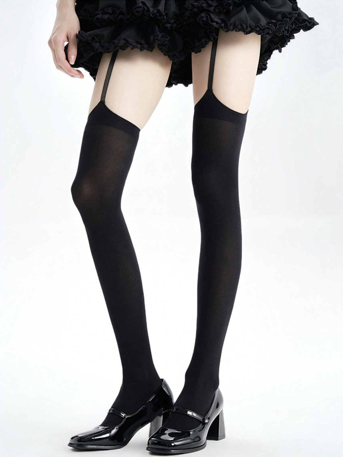 Black thigh high stockings, straps rising from the top band