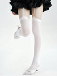 Cargar la imagen en la vista de la galería, White garter stockings worn with heels, leg raised
