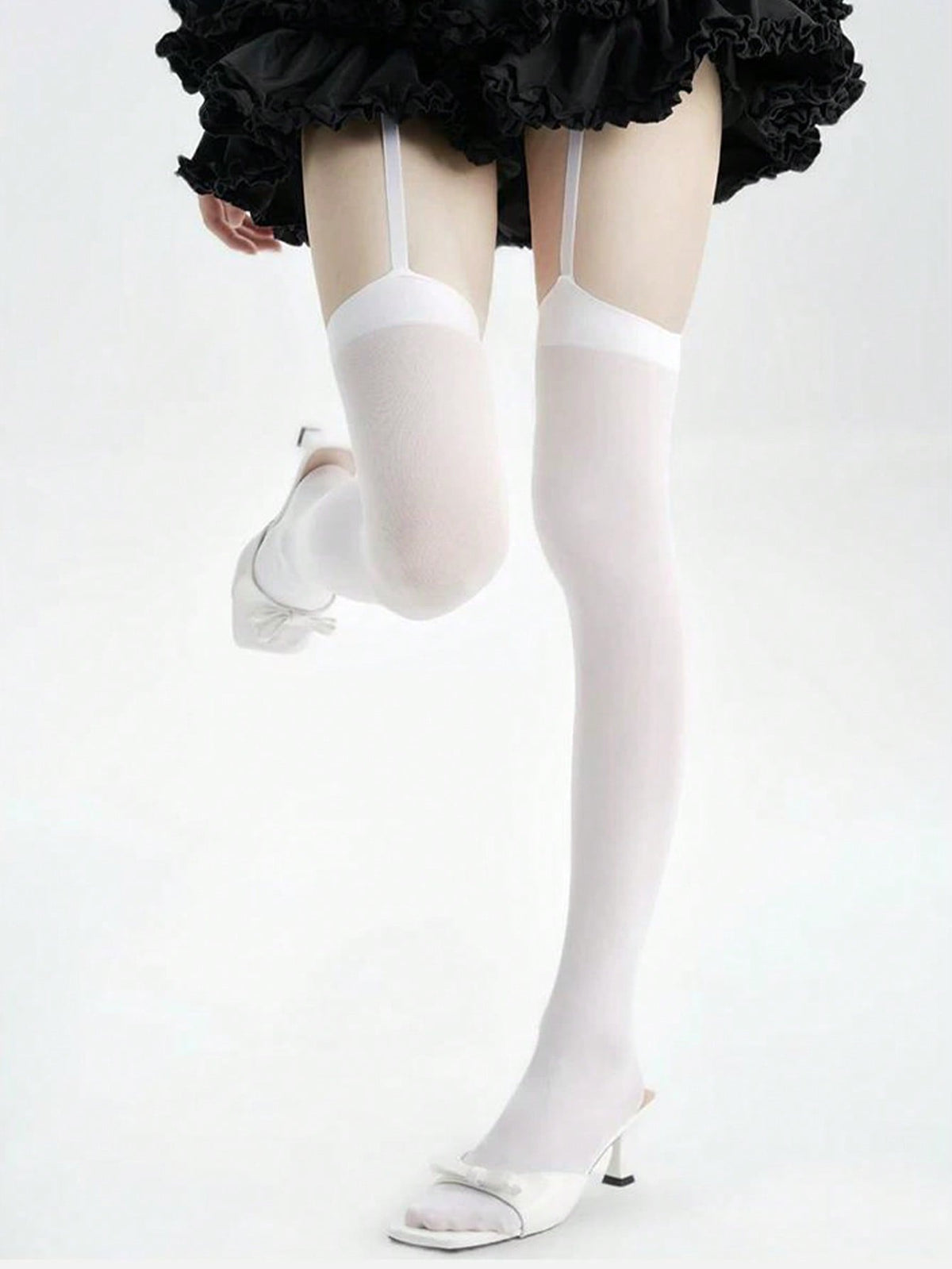White garter stockings worn with heels, leg raised