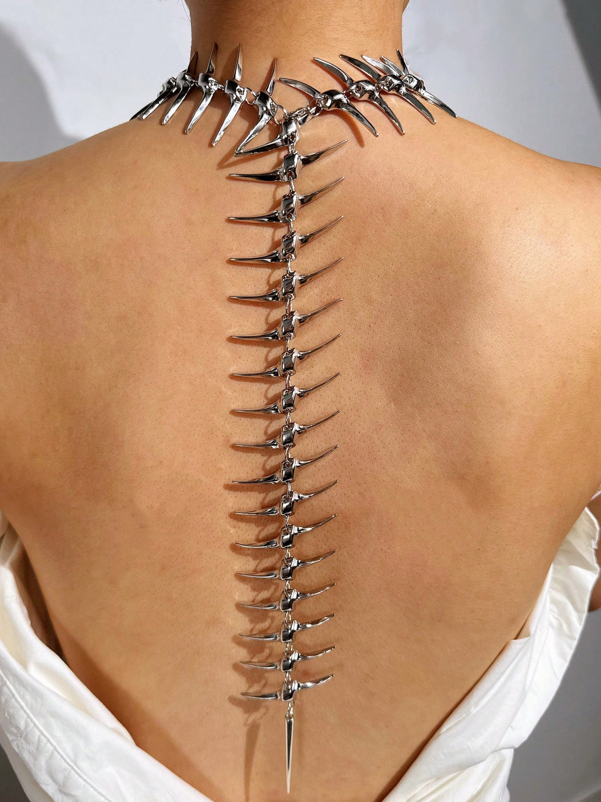 The spiked collar section shown worn at the neck and shoulder