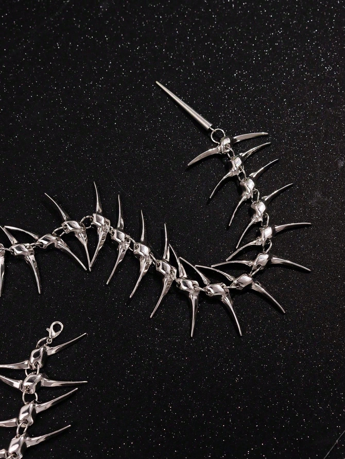 Close view of the tapered spikes, links and lobster clasp