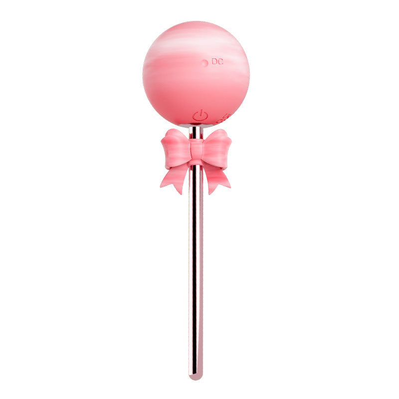 Pink lollipop vibrator with silicone candy head, bow accent and slim polished shaft
