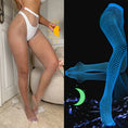 Load image into Gallery viewer, White fishnet tights in daylight beside the same tights glowing blue in the dark
