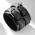 Load image into Gallery viewer, Wide black faux leather cuff bracelet with two silver-tone buckles, three-quarter view
