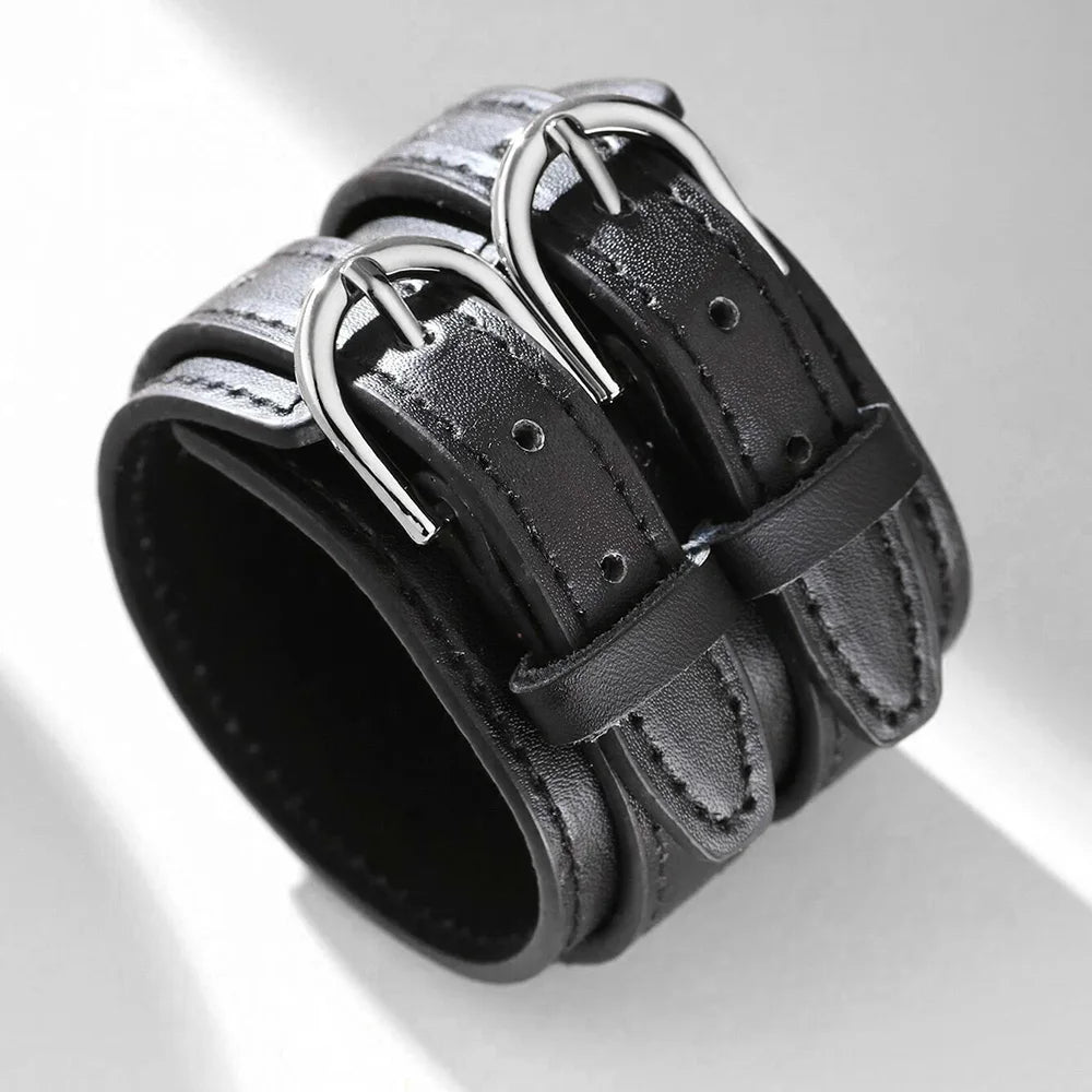 Wide black faux leather cuff bracelet with two silver-tone buckles, three-quarter view