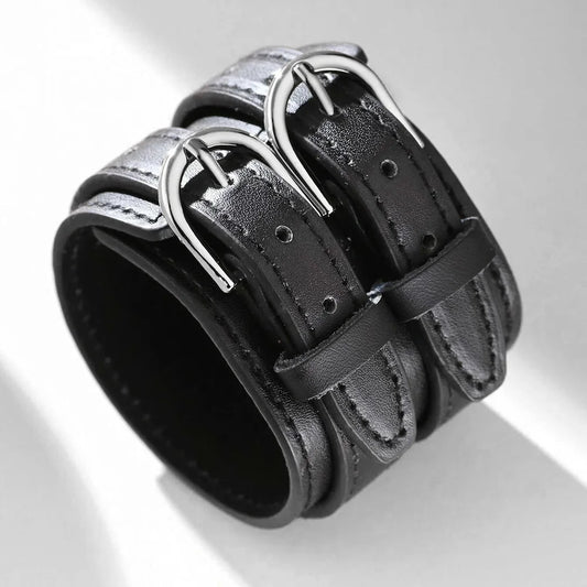 Wide black faux leather cuff bracelet with two silver-tone buckles, three-quarter view