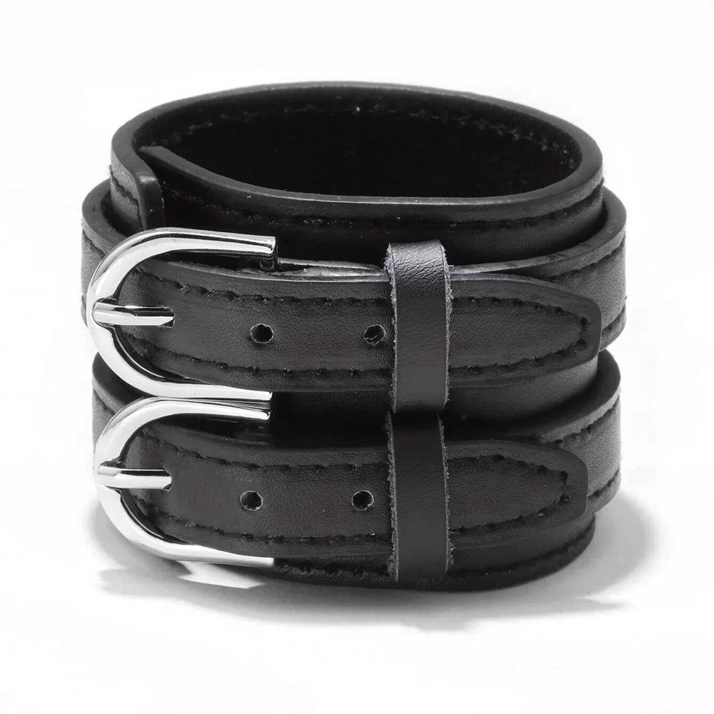 The cuff laid flat, showing the full width of the strap and both buckle straps