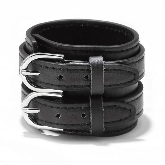 The cuff laid flat, showing the full width of the strap and both buckle straps