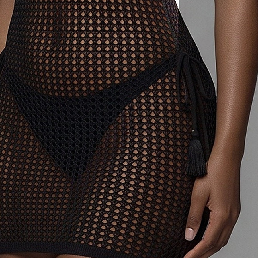 Hip detail showing the black net over the thigh, the ribbed hem and a tasselled swimwear tie