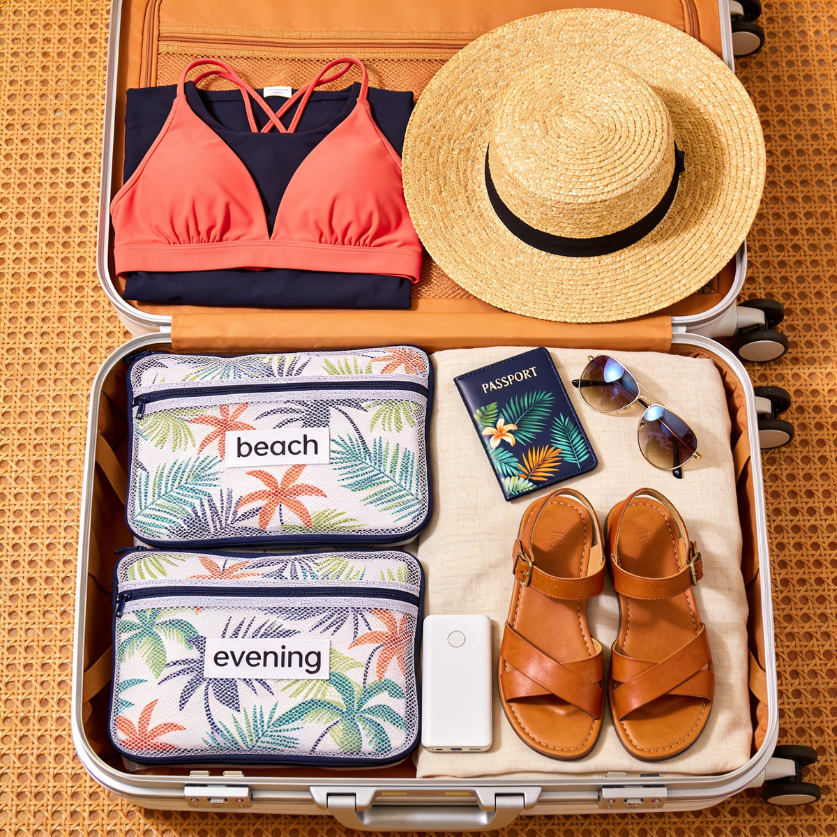 Flat-lay of a packed Carnival Horizon cruise suitcase for a couple