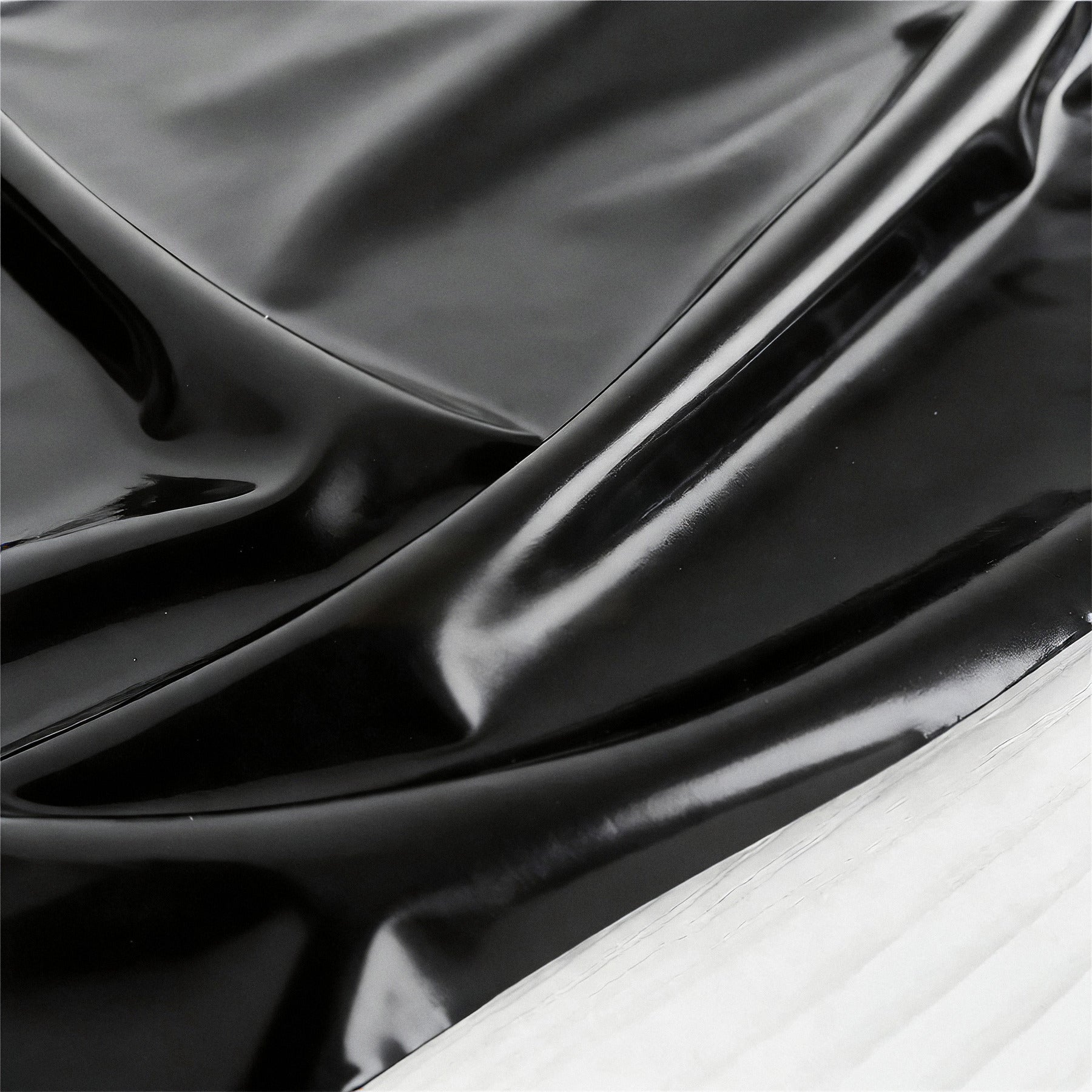 Close-up of the high-gloss black PVC surface
