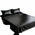 Load image into Gallery viewer, Glossy black waterproof sheet made up on a bed with pillows

