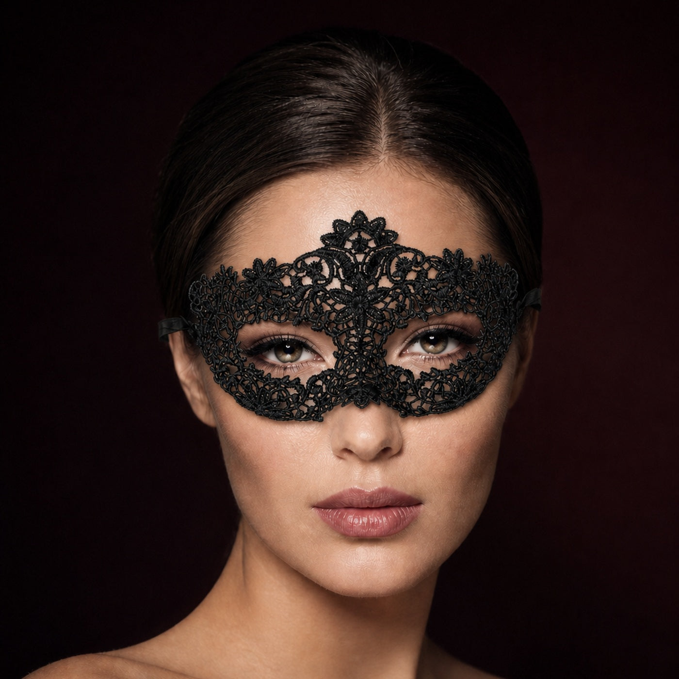 Black filigree lace masquerade mask worn, front portrait