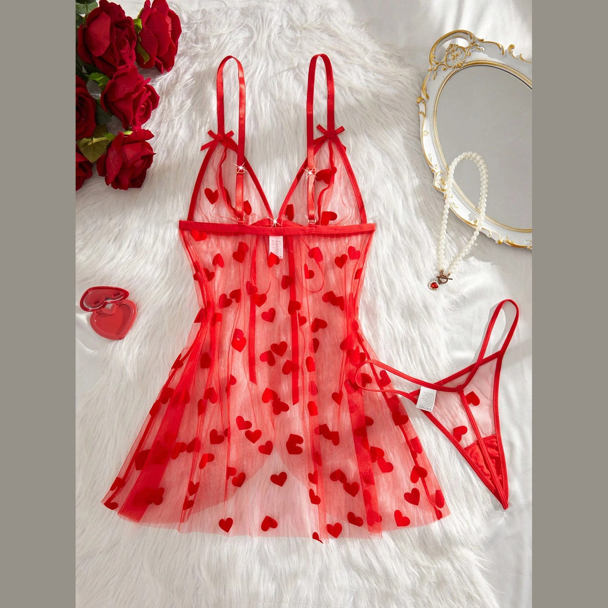 Red heart-flock mesh babydoll and matching thong laid flat