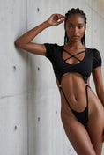 Load image into Gallery viewer, Leaning against a concrete wall, arm raised, showing the side cut-outs

