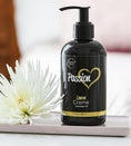 Cargar la imagen en la vista de la galería, Massage oil bottle on a bedside tray next to a white chrysanthemum

