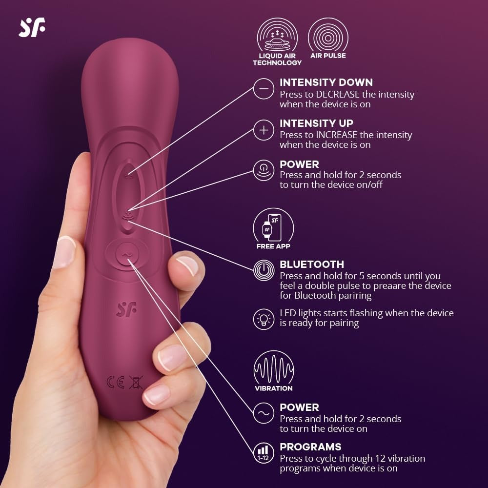 The wine red stimulator held in a hand with every button and the Bluetooth pairing labelled