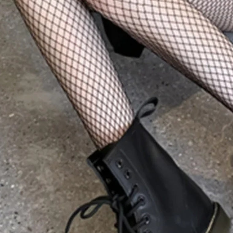 Detail of the S grid diamonds across the thigh above a boot