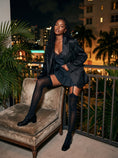 Cargar la imagen en la vista de la galería, Black garter stockings worn with a lace camisole and tailored blazer on a balcony
