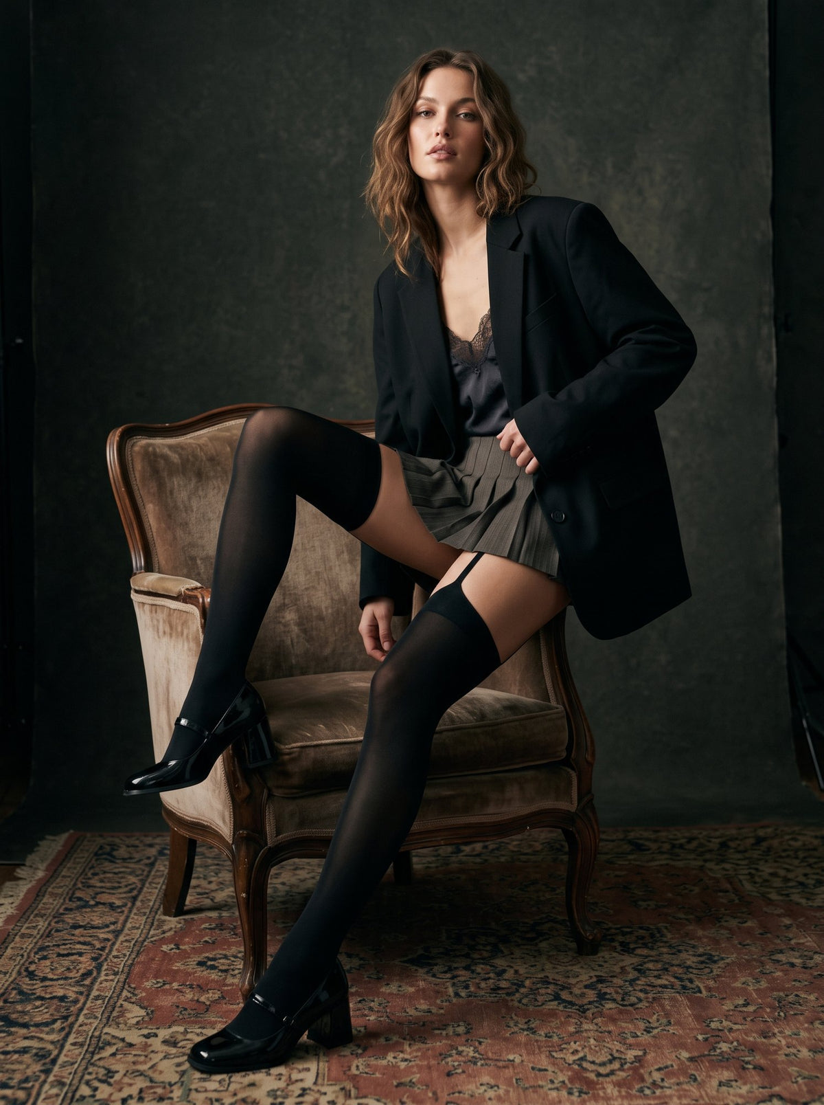 Seated view showing the sheer black leg below the opaque top band and one strap on the thigh