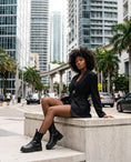 Cargar la imagen en la vista de la galería, XS micro-net fishnet tights with a blazer and combat boots on a concrete ledge in downtown Brickell
