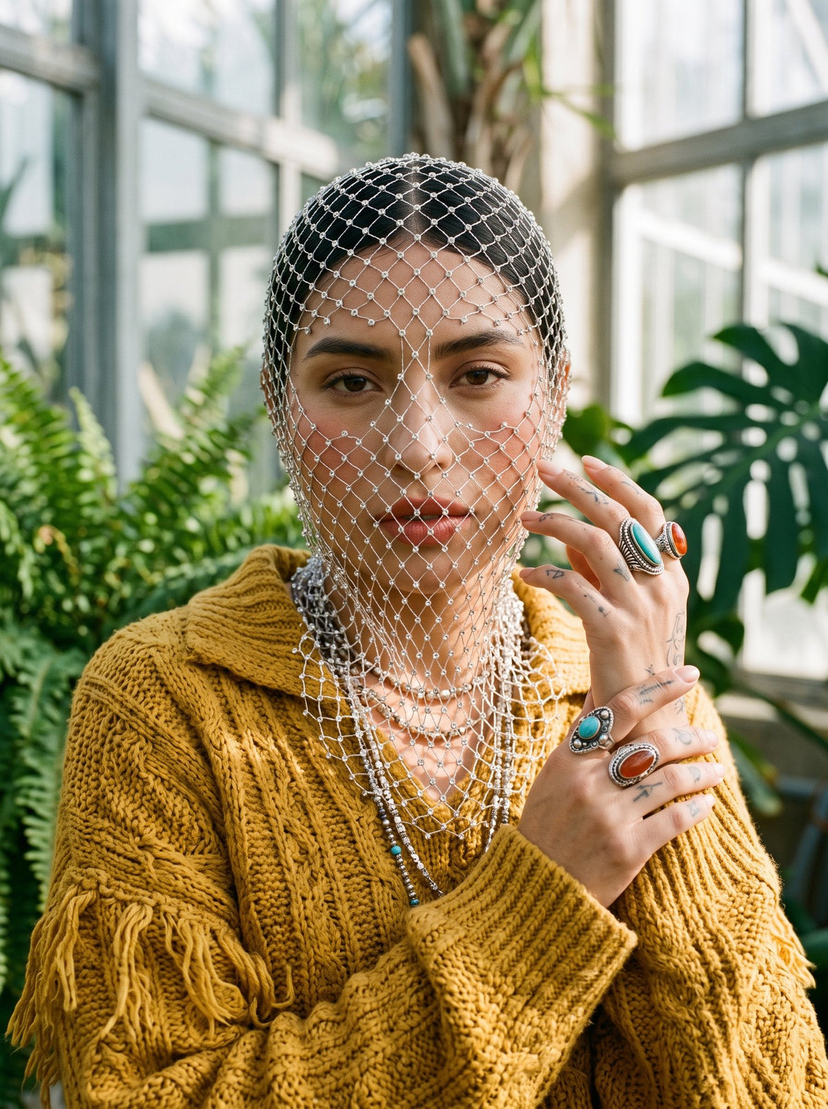 Pearl diamond-net veil over the crown and face in daylight, worn with a knit sweater