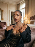 Cargar la imagen en la vista de la galería, Pale rhinestone net veil over a black satin slip and tailored jacket in a bright interior
